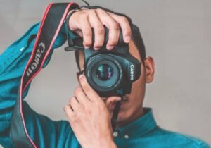 Man Taking Photo Using Black Canon Camera